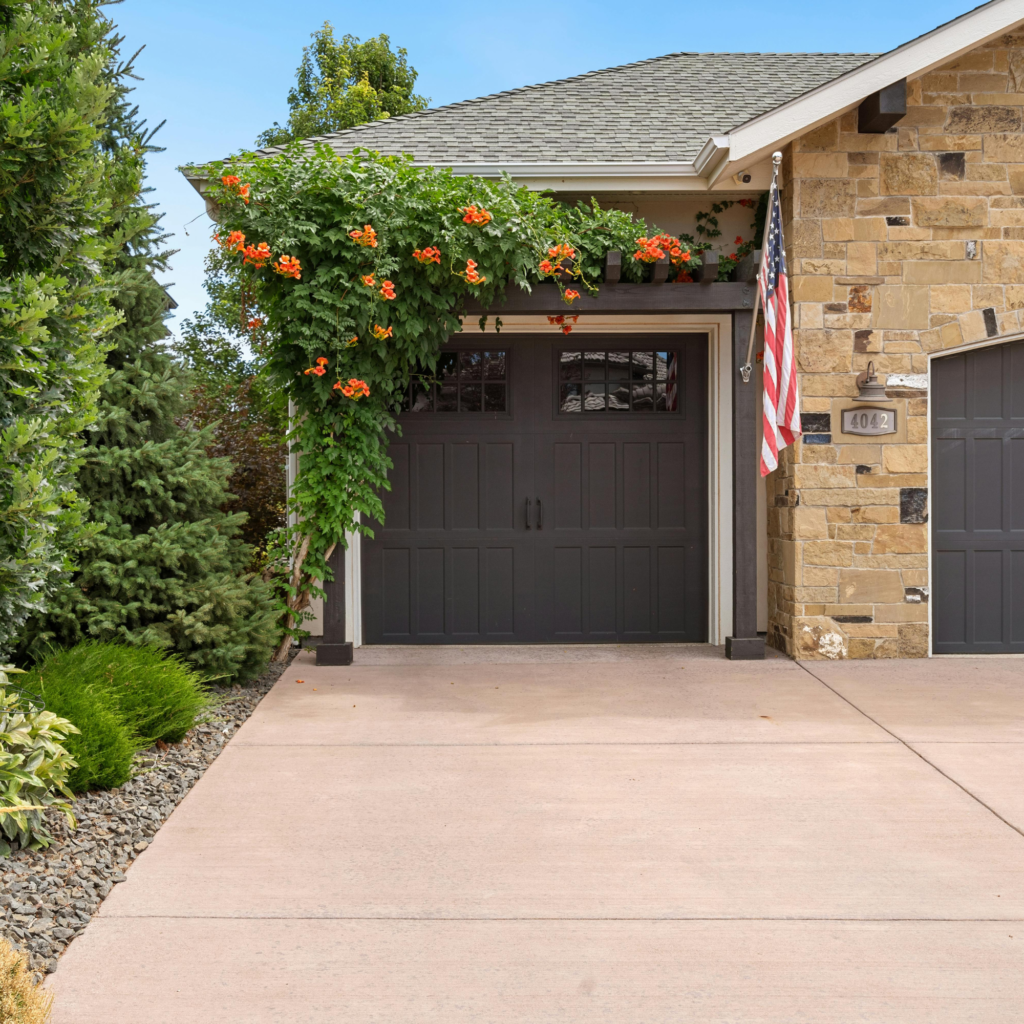 Residential garage door and home exterior with American flag, Miramar FL repair services.