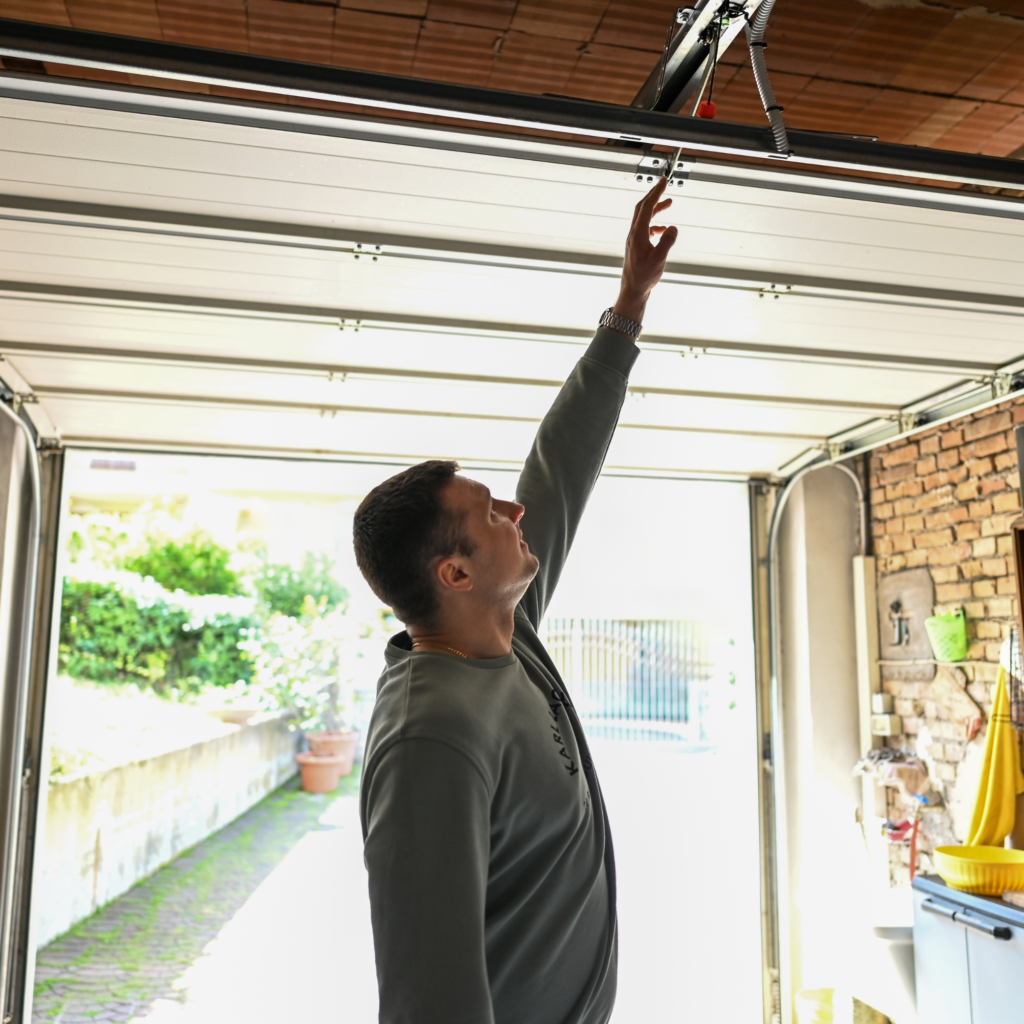 Technician repairing commercial garage door spring in Miramar, FL